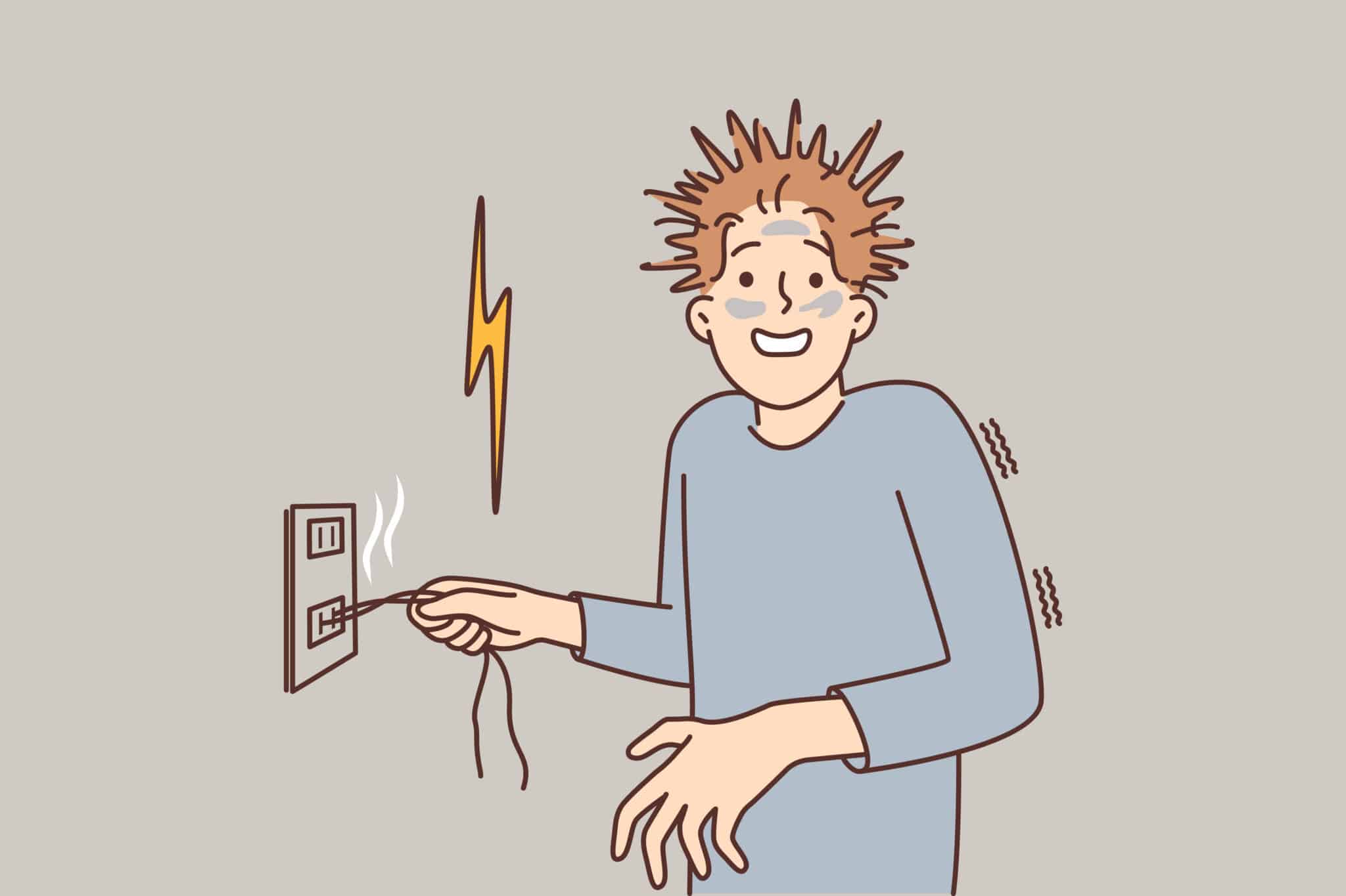 A man who received an electric shock has shaggy hair and is holding onto a wire sticking out of an outlet.