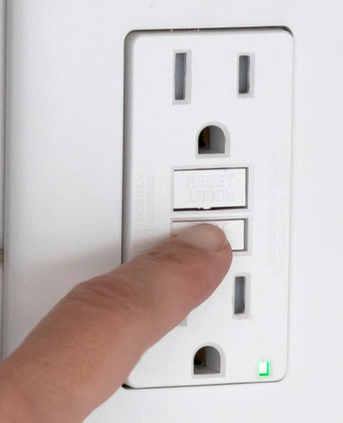 Pressing the test button on the GFCI outlet, GFCI Outlet Testing.