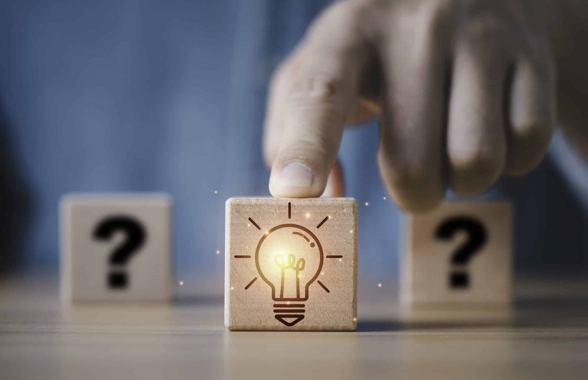 Wooden blocks with glowing light bulb block in front of question mark, Whole house generator testing.