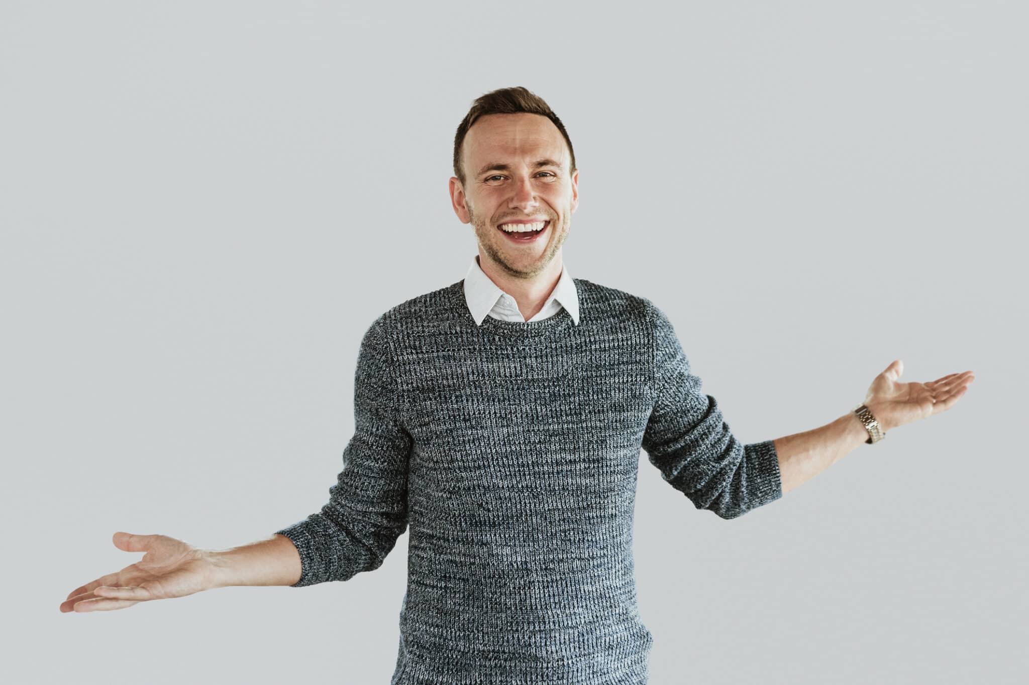Man smiling with arms outstretched, Generator coolant checks.